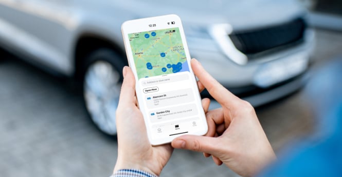 Person holding phone looking at map of locations
